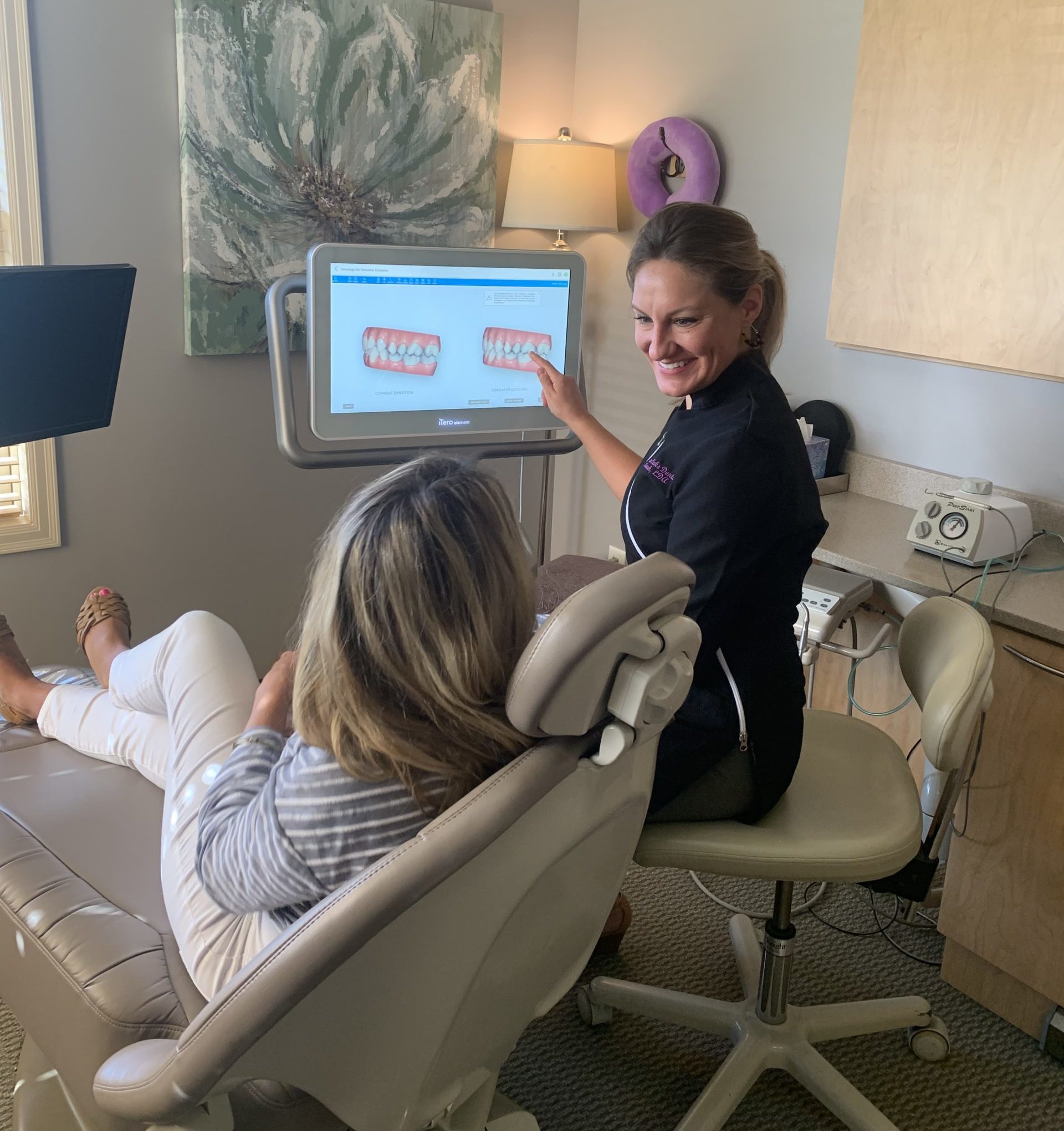 Our dental staff showing a patient a 3D model of her teeth